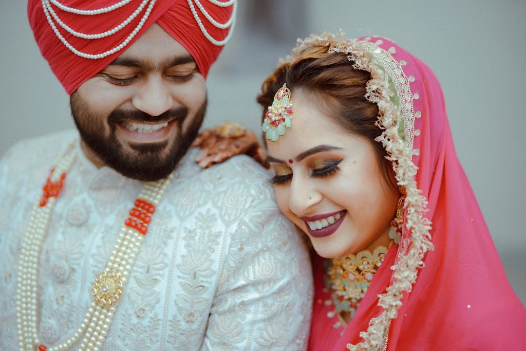 A couple in traditional attire smiling for the camera