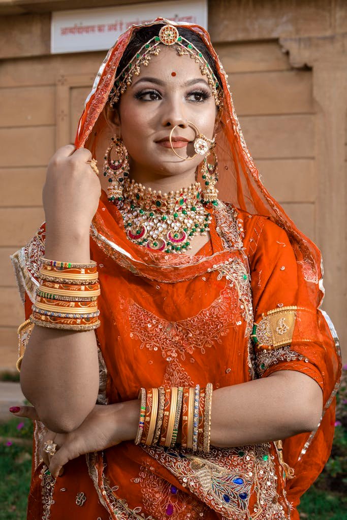 A Woman in Orange and Gold Sari Dress