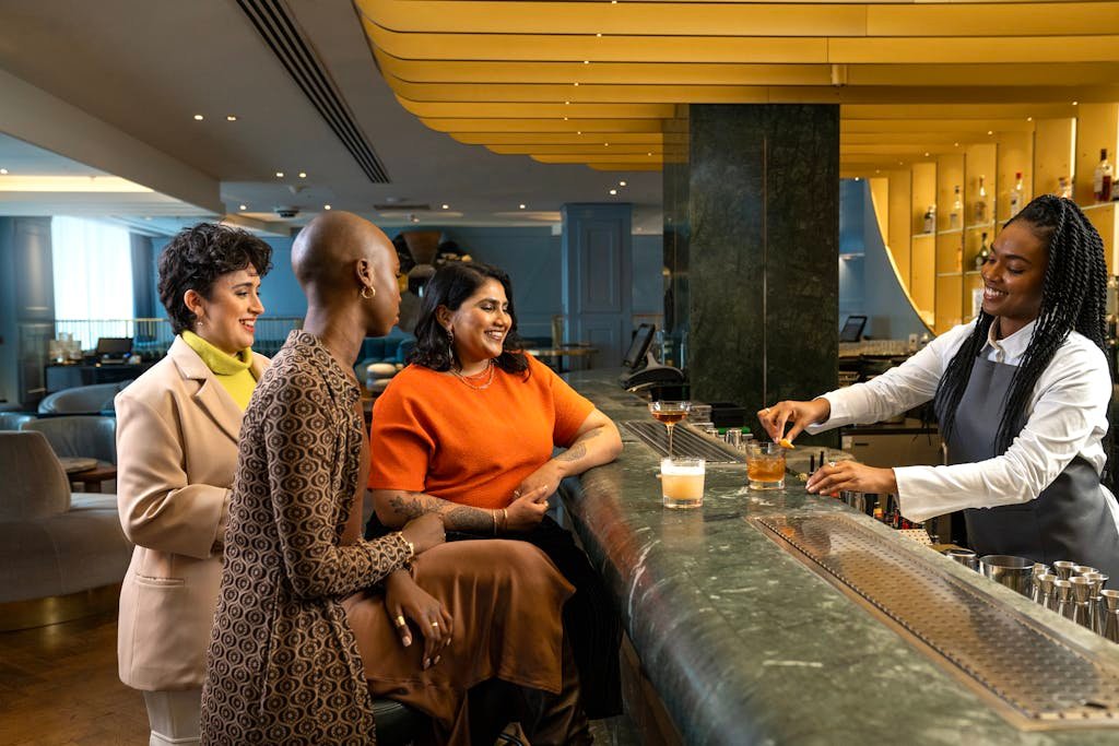 Women drinking whisky at a bar